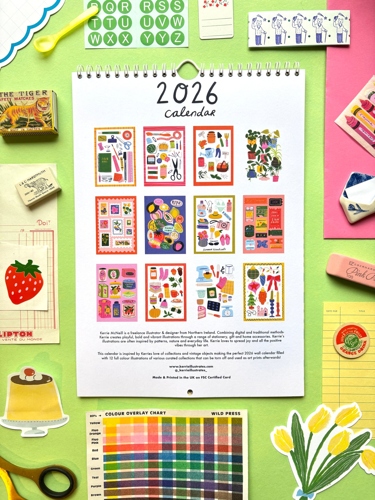 2026 calendar with colorful design on a green background with stationery items.