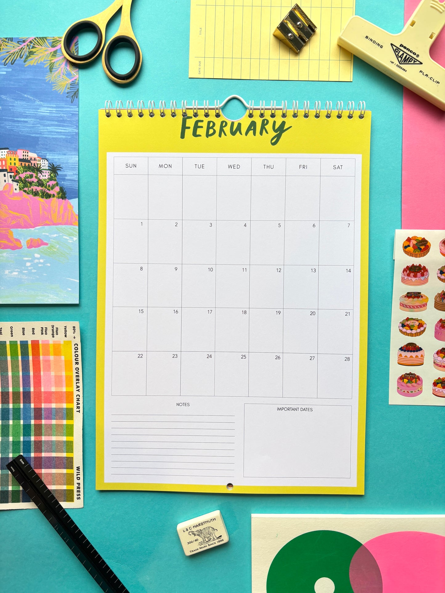 Calendar for February on a colorful background with stationery items