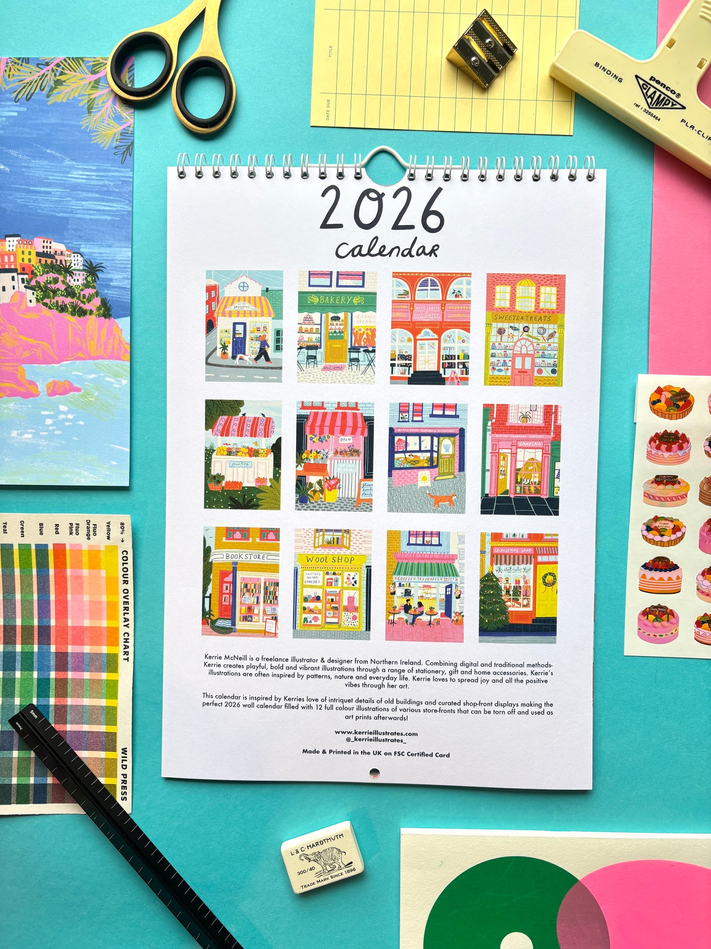 2026 calendar with colorful illustrations on a blue background with stationery items.