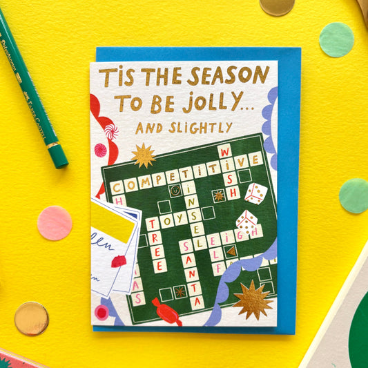 Tis the Season to Be Jolly and Slightly Competitive’ Christmas card – Scrabble-inspired festive greeting card for families and board game lovers.