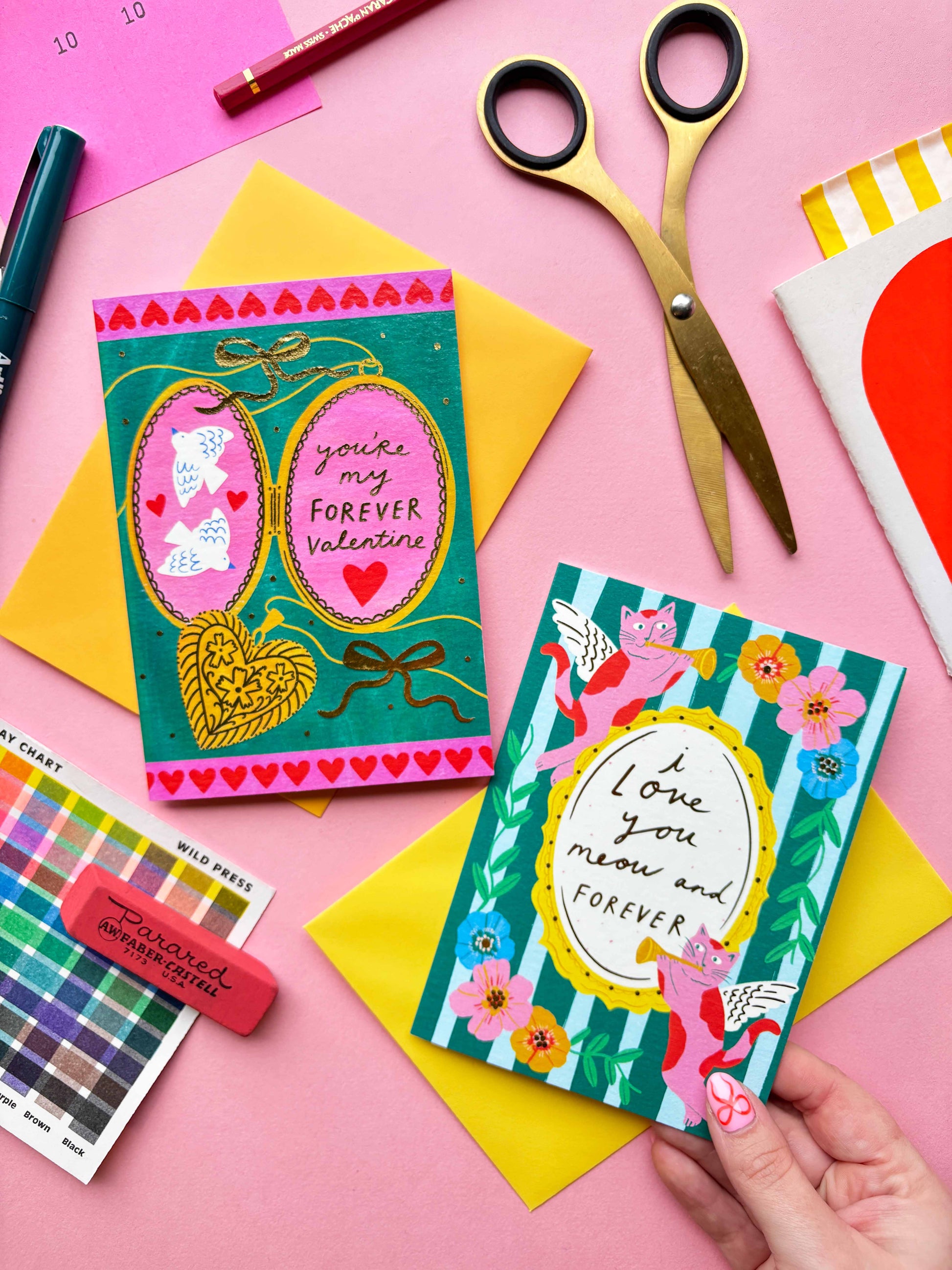 I love you meow and forever is a greeting card created by Kerrie McNeill (Kerrie Illustrates) based in Northern Ireland. This card is blue and green striped with cat cherubs and floral motifs around the edges of the hand-written caption