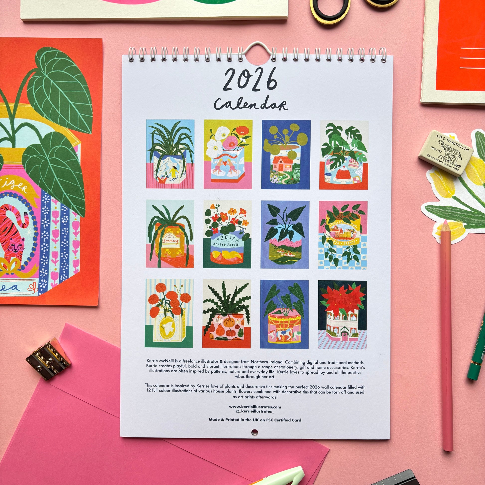 2026 calendar with plant-themed design on a pink background with stationery items.