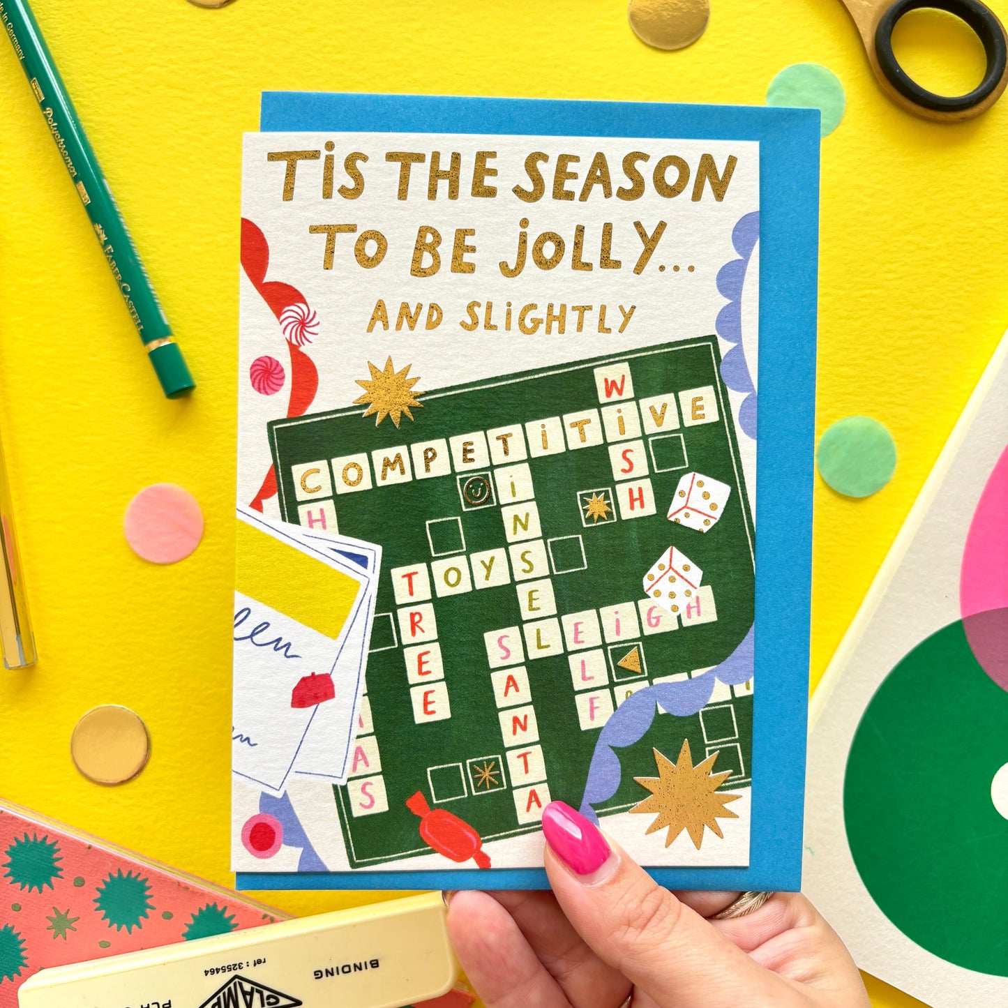 Festive Christmas greeting card with Scrabble board illustration surrounded by bunting, stars, and sweets – ideal for board game fans and family Christmas gifts.